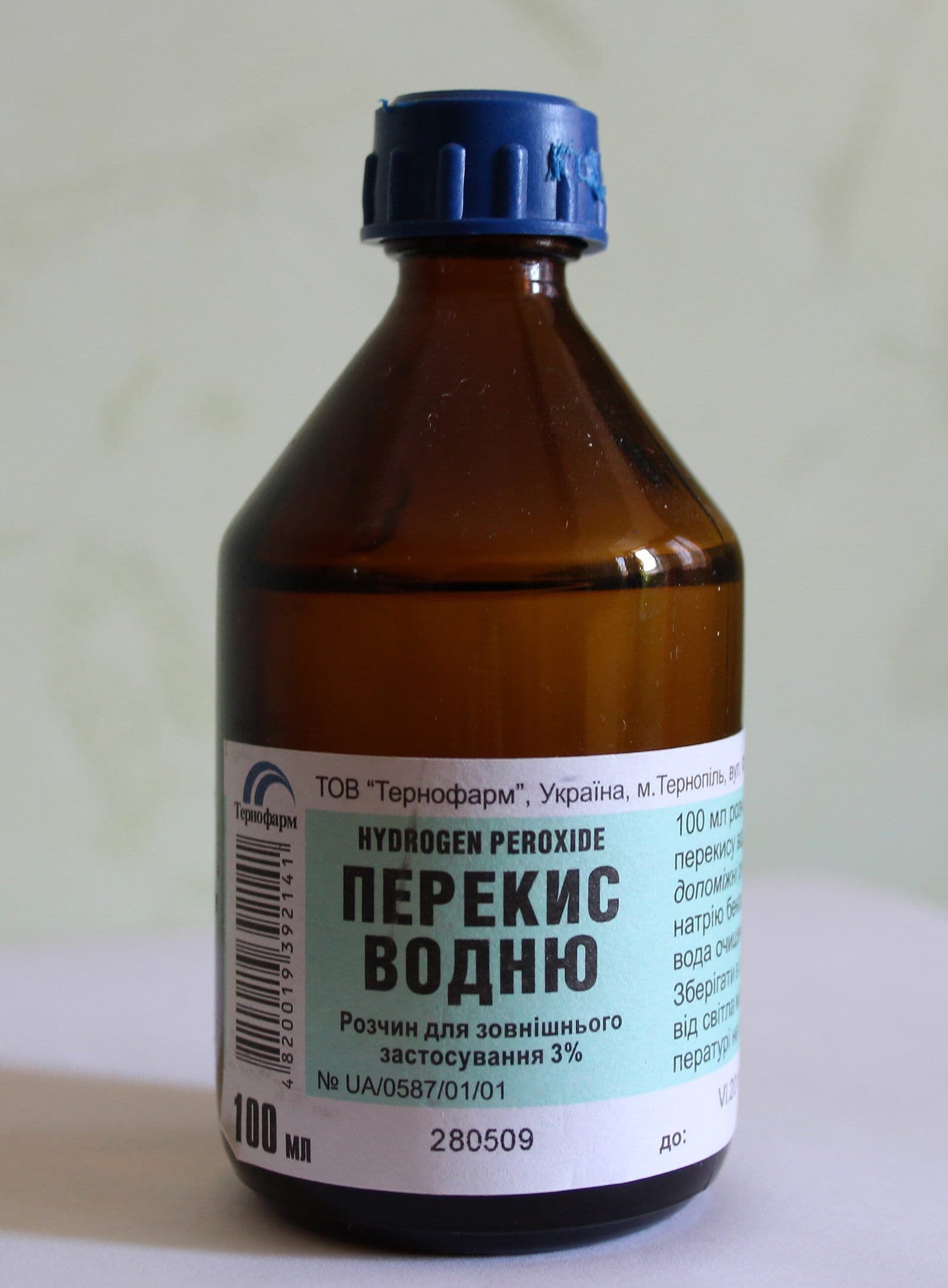 A brown glass pharmacy bottle of hydrogen peroxide solution